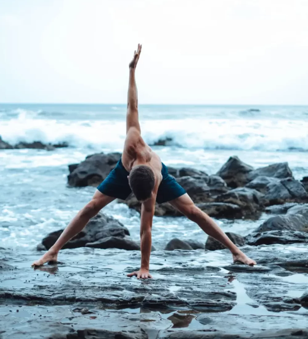Man at yoga retreats by the sea
